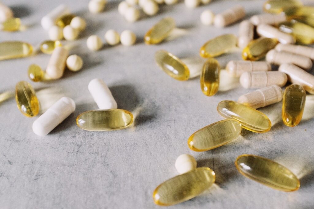 white and golden dietary supplement pills